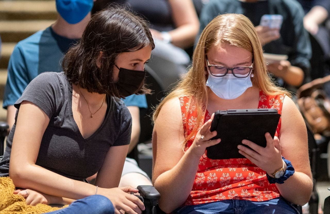 Students studying an iPad during class