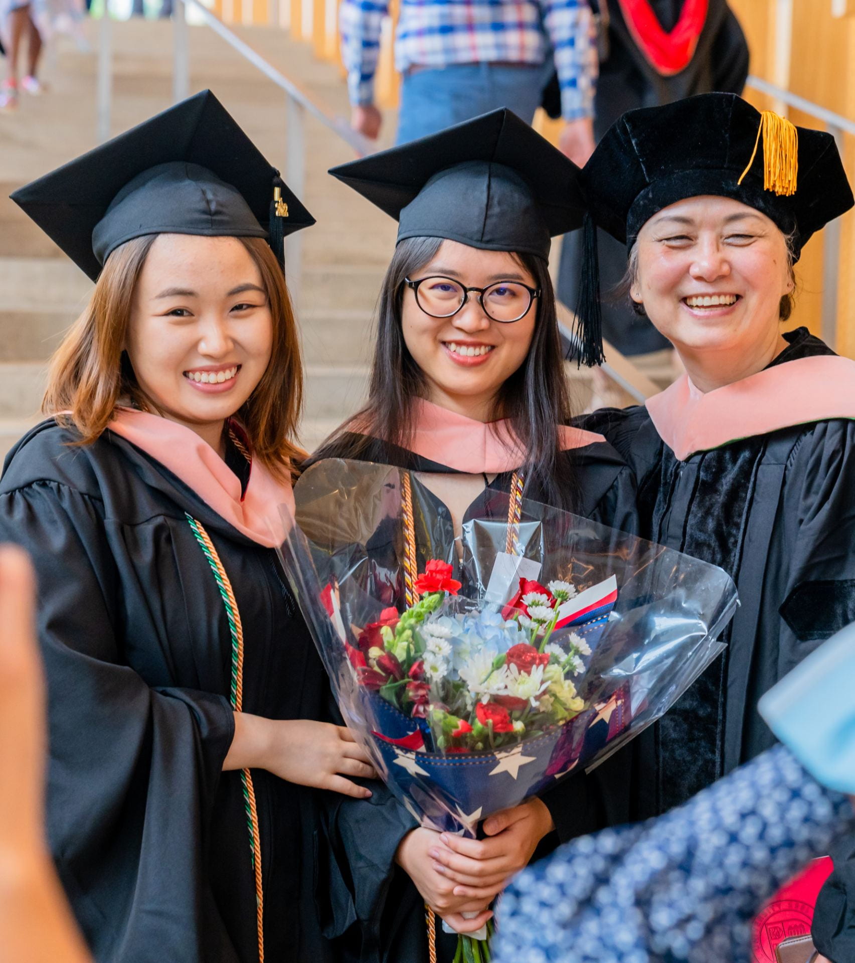 2 MPH graduates with Dr. Li at graduation